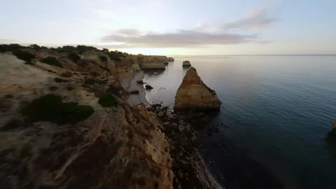 Sunrise over coastal cliffs with still water Video stock 346091646