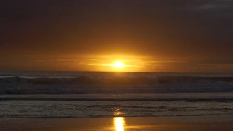 Sunrise over crashing waves on empty beach, summer day, birds flying over Stock Footage 132168621