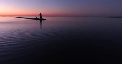 Sunrise over the Delaware Bay with a Lighthouse, off of Cape May, drone Stock Footage 143206549
