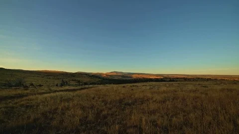 Sunrise over empty yellow fields light illuminates Kiger Mustang Viewing Area Stock Footage 81897861