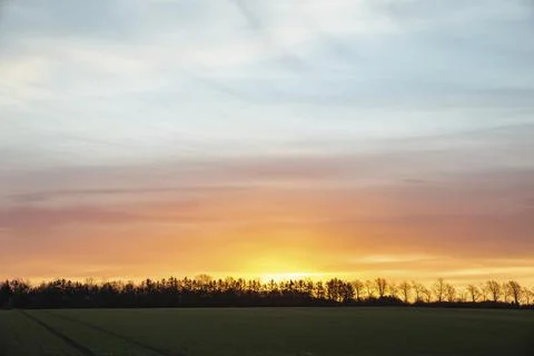 Sunrise over a field in Denmark. Rural landscape Stock Photos