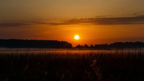 Sunrise over field time lapse Stock Footage 71657187