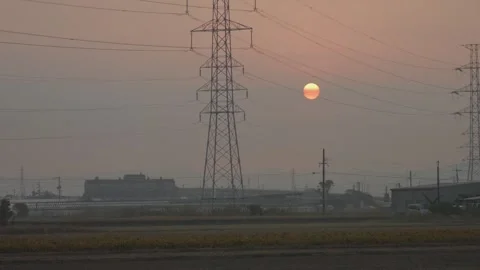 Sunrise Over FIelds and Electrical Grid in background, Mizuma District, Fukuoka Stock Footage 266395864