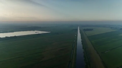 Sunrise Over Fields and Lake Aerial Drone Shot in the Netherlands Stock Footage 317401427