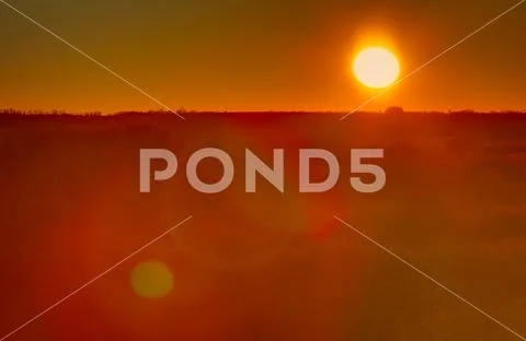 Sunrise over the forest. Photographed with a telephoto lens. Stock Photos