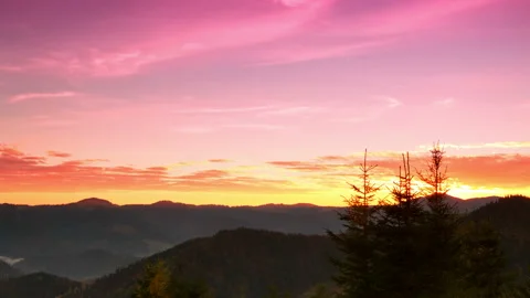 Sunrise over the Forested Mountains. Time Lapse 4K 動画素材 106463736