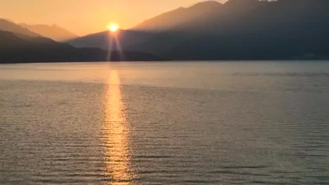 Sunrise Over Lake with Sun Rays Reflecting in Straight Line on Water – 4K Video Stock Footage 316418320