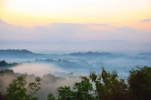 Sunrise over merapi volcano and borobudur temple, indonesia 写真素材