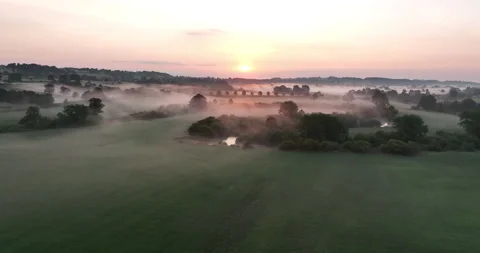 Sunrise over misty fields Stock Footage 219975751
