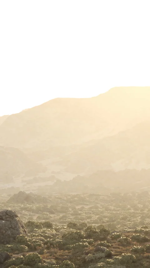 Sunrise over a mountain landscape with soft light and distant hills Stock Footage 335690687