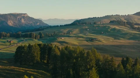 Sunrise over Mountain Meadows with Small Wooden Cabins and Green Forests Stock Footage 331168586