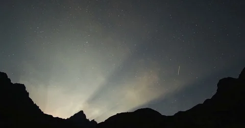 Sunrise over the mountain peaks with bright beautiful rays under the starry s Stock Footage 84743736