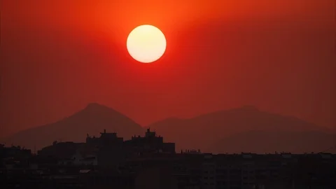 Sunrise over mountains and city buildings silhouette Stock Footage