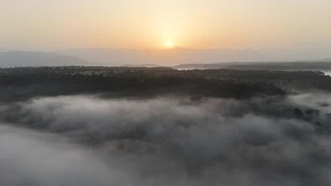 Sunrise over mountains with clouds in foreground  Stock Photos