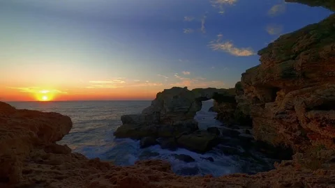 Sunrise over naturally made arc in the cliffs - Time-lapse Stock Footage 148514484