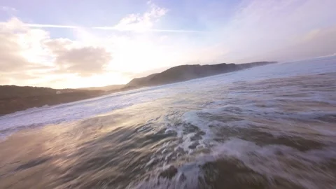 Sunrise over ocean with frothy waves Video stock 344677459