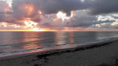 Sunrise over Ocean at Jupiter Beach with Clouds and waves shot with crane Stock Footage 100579884