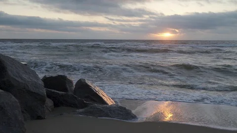 Sunrise over the ocean by the rocks Stock Footage 98509116