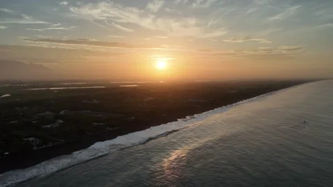 Sunrise over Pacific coast with waves rolling onto black sand beach Video stock 339216265
