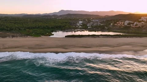 Sunrise over the Pacific Ocean looking back towards palm tree estuary Stock Footage 236741231