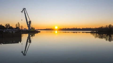 Sunrise over the river in the background of a floating crane. Stock Footage 86788862
