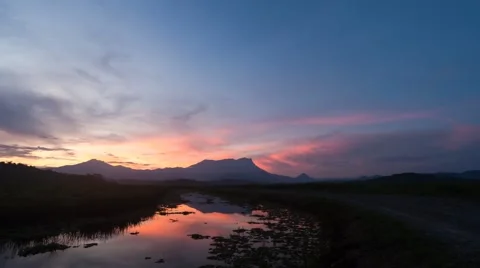 Sunrise over river with mountain background time lapse Stock Footage 43047976