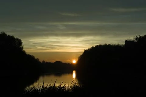 Sunrise over the river Stock Photos