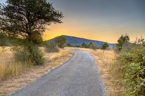 Sunrise over road in Causse Blandas Stock Photos