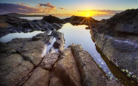 Sunrise over rocks Stock Photos