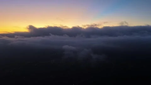 Sunrise Over Rolling Clouds Above Distant City Video stock 345495535