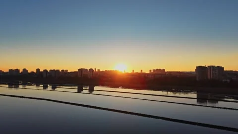 Sunrise over salt fields near urban area Stock Footage 328530376