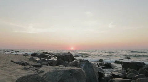 Sunrise over the sea and rocky coast Stock Footage