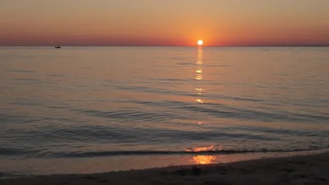 Sunrise over the sea. Dramatic burning sky with golden reflection on water Stock Footage 253566651