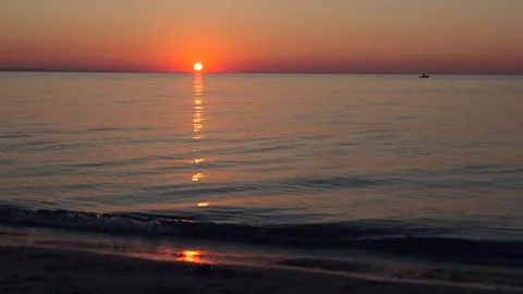 Sunrise over the sea. Dramatic burning sky with golden reflection on water Stock Footage 253777925