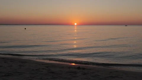 Sunrise over the sea. Dramatic burning sky with golden reflection on water Stock Footage 253875050