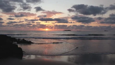Sunrise over the sea with reflections on the beach and water Stock Footage 265039587