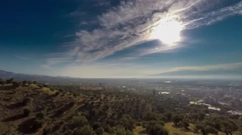 Sunrise over a small town. Overlooking of valley with rolling green hills and Stock Footage 61750361