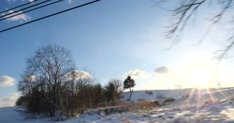 Sunrise over a snowy winter landscape with sunburst Video stock 171908176