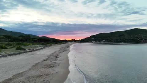 Sunrise Over Tranquil Beach with Gentle Waves – 4K Aerial Footage Stock Footage 310179527