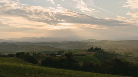 Sunrise over Vineyard fields and cypress trees in Tuscany Italy in 4K Time-lapse Stock Footage 99786785
