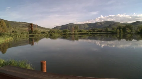 Sunrise pond with reflection of mountain sky Stock Footage 50123133
