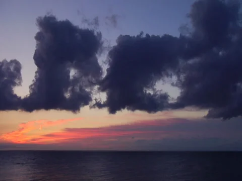 Sunrise Purple Clouds with Red Sky Over Water Видео 34260835