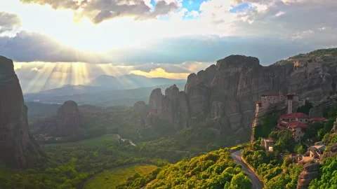 Sunrise rays of sun light through clouds. Greece Meteora monastery in Europe Stock Footage 337169678