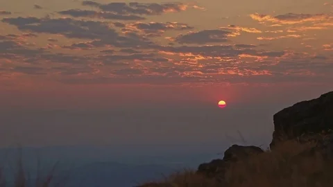 Sunrise red sun peeking through clouds over Alvord Desert from summit of Steens Stock-Footage 81897953