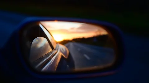 Sunrise reflected in car wing mirror on country road uk Stock Footage 120561247