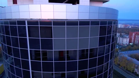 The sunrise is reflected in the glass wall of a skyscraper.Close-up. Stock Footage 131768095