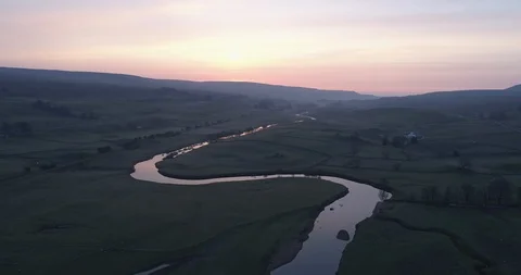 Sunrise reflecting on a calm river Stock Footage 108750058