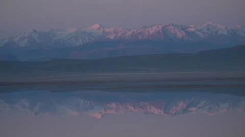 Sunrise reflection of Central Tien Shan mountains in Tuzkol Lake, Kazakhstan Stock Footage 333913134