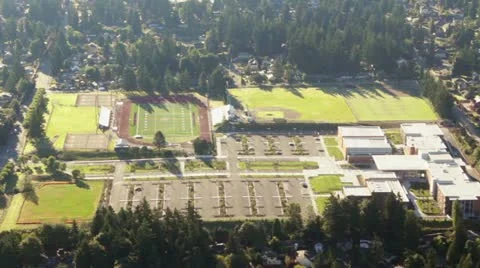 Sunrise Reflection Passing Over High School Aerial View Stock Footage 12379256