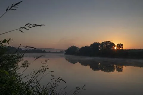 Sunrise on a river Stock Photos